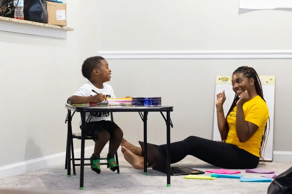 An adult and child doing a hands-on activity together